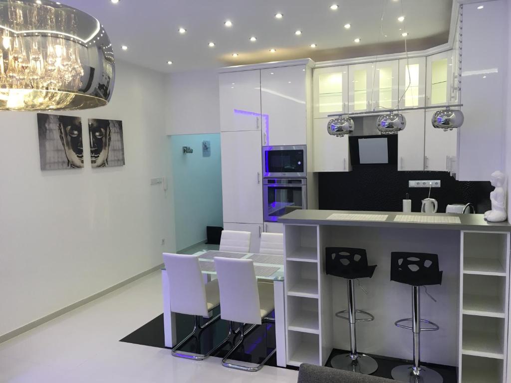 a kitchen with a counter and stools in a room at Synagogue Gozsdu Private Apartments in Budapest