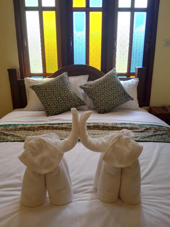 Postel nebo postele na pokoji v ubytování Baan Bussaba Hotel