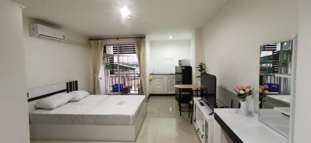 a bedroom with two beds and a kitchen with a table at Chiang Mai view place in Ban Hua Phrong