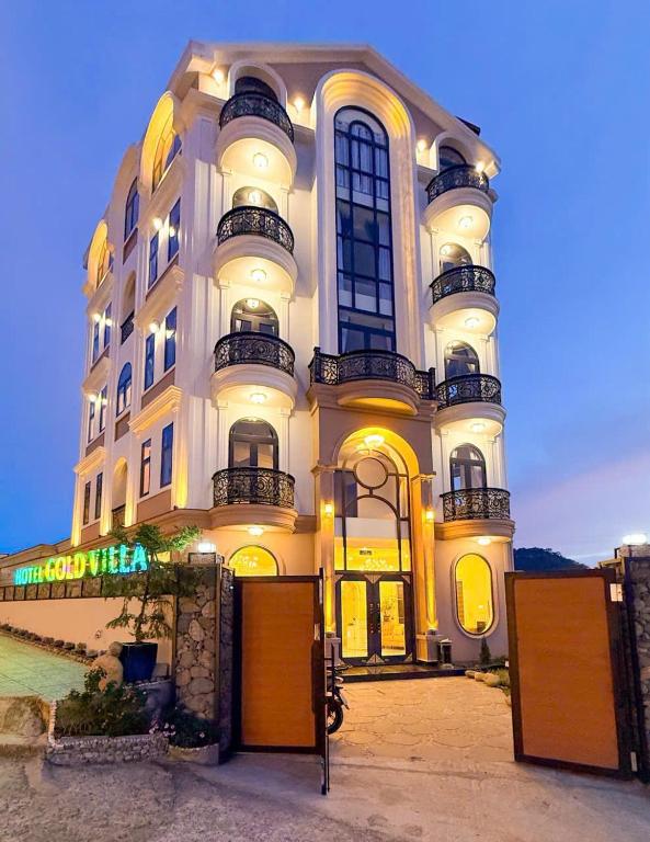 a large white building with many windows on it at Gold Villa in Trai Mat