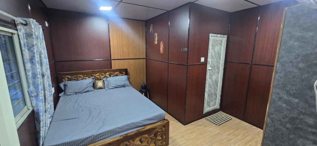 a small room with a bed in a boat at Nishatana Farm Stay in Bangalore