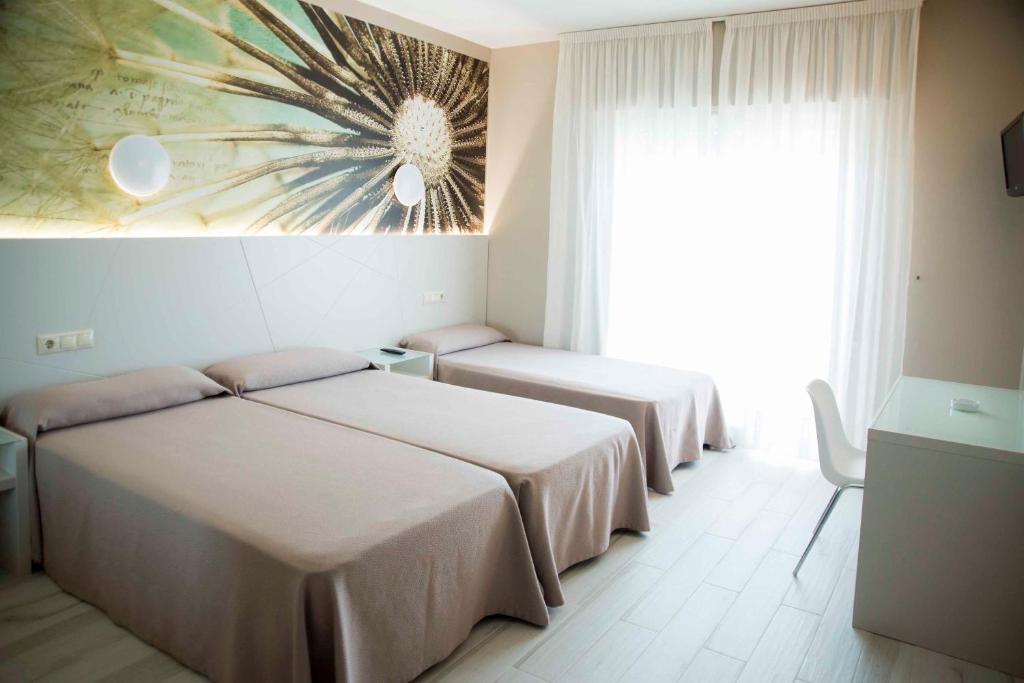 Postel nebo postele na pokoji v ubytování Hotel Luz de Luna