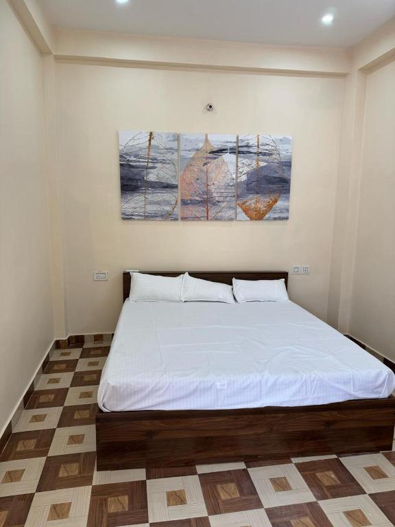 a bedroom with a large white bed in a room at Hari Vatika in Varanasi