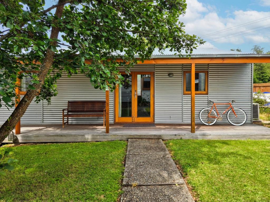 a house with a bike parked in front of it at Naseby Apartments in Naseby