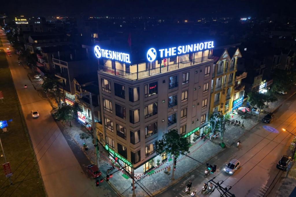 a building with a sign on top of it at night at The Sun Hotel - Ninh Bình in Kỳ Vĩ
