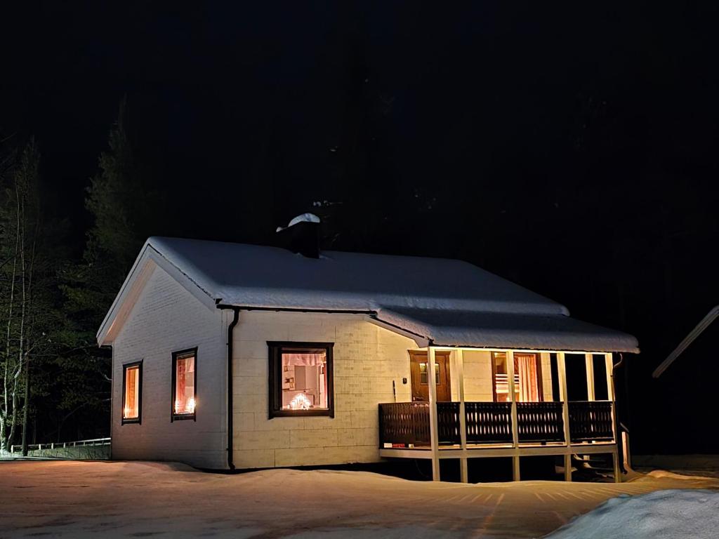 a small house with a window at night at Stuga in Auktsjaur in Auktsjaur