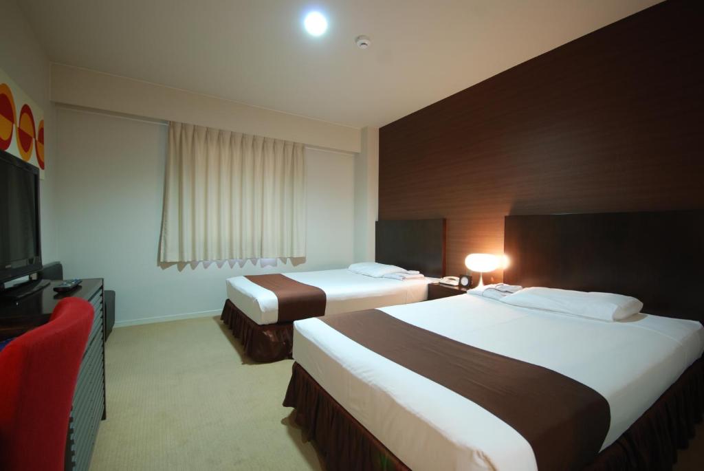 Postel nebo postele na pokoji v ubytování Kokusai Hotel Yamaguchi