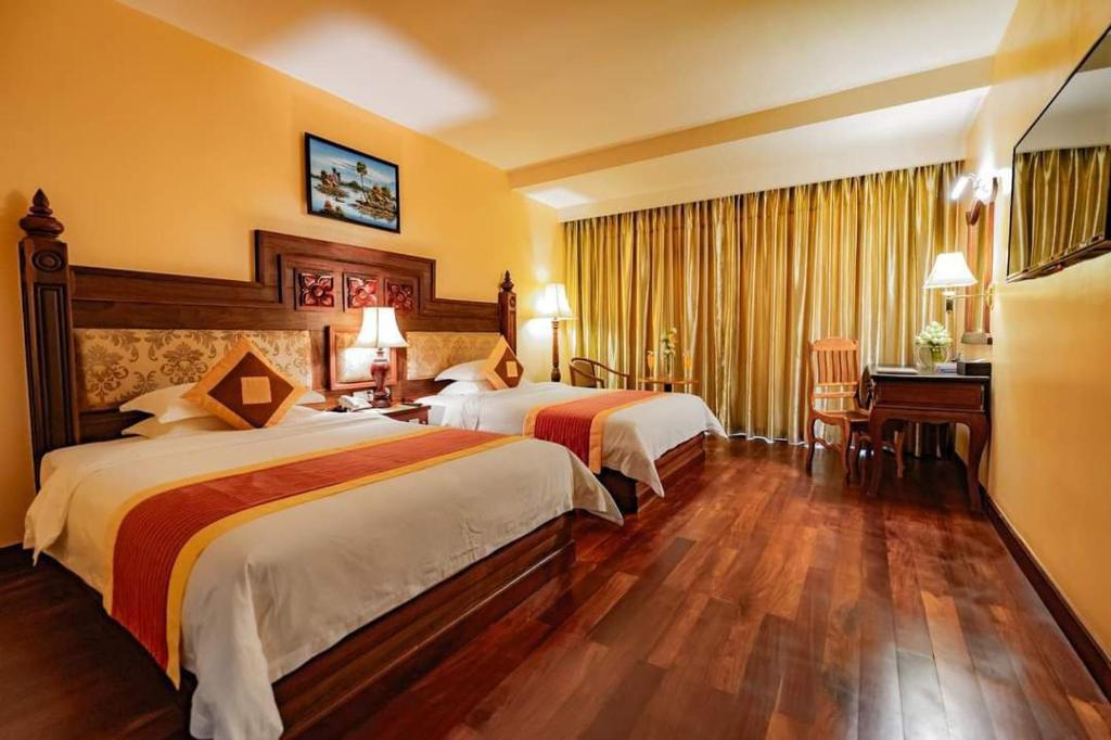 Llit o llits en una habitació de Angkorian Hostel