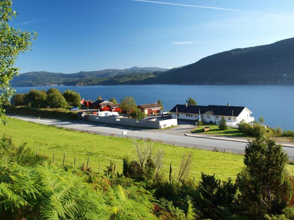 a view of a lake with houses and a road at Langenuen Motel & Camping in Stord