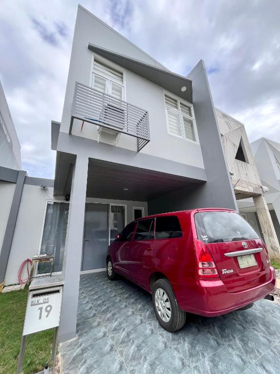 a red van parked in front of a house at Vibe and Stay - Staycation home near Tagaytay in Calo