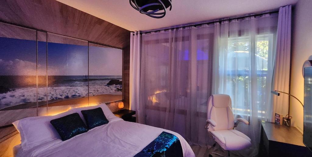a bedroom with a bed and a chair and a window at Ocean Spa Oasis in Port Saint Lucie