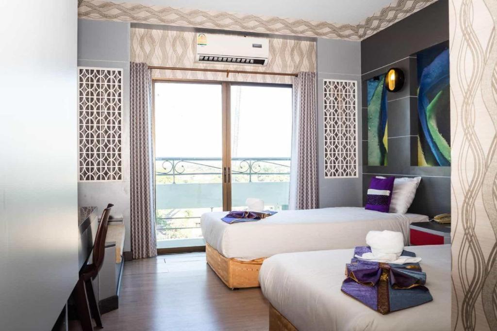 En eller flere senge i et værelse på Phitsanulok Orchid Hotel