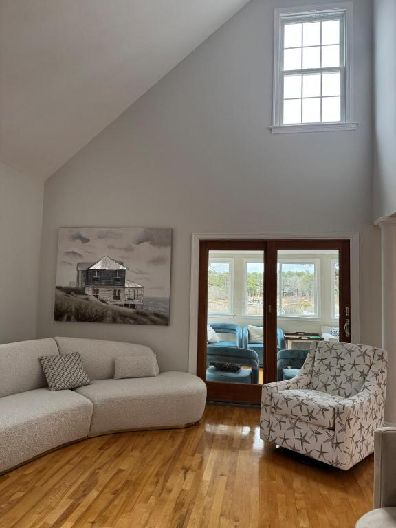 a living room with a couch and a chair at Serene waterfront getaway in Mashpee