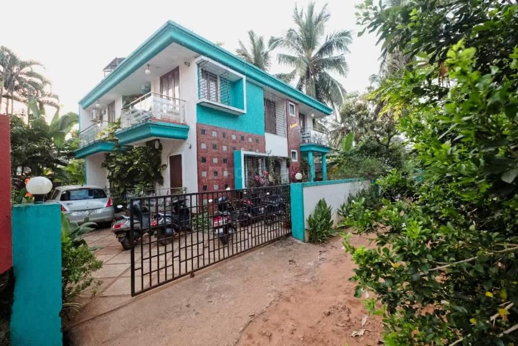 a house with a gate in front of it at Celeste holiday homes in Calangute