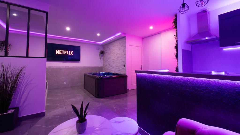 a salon with purple lighting and a reception counter at MagicSpa91 in Chilly-Mazarin