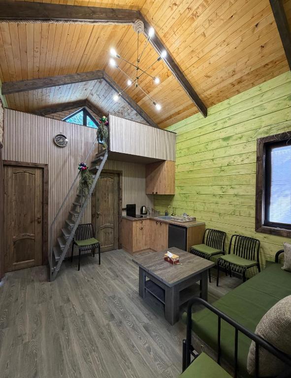 a living room with a spiral staircase in a house at Arte Jermuk #3 in Jermuk