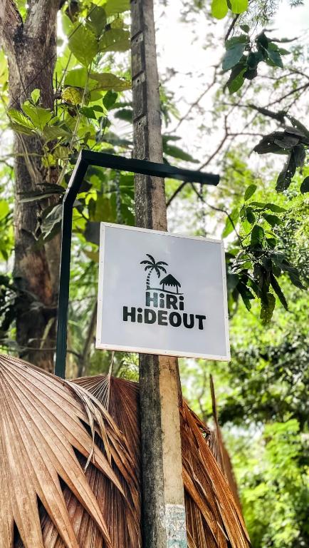 a sign on a tree with a life h absorb sign at Hiri Hideout in Dickwella