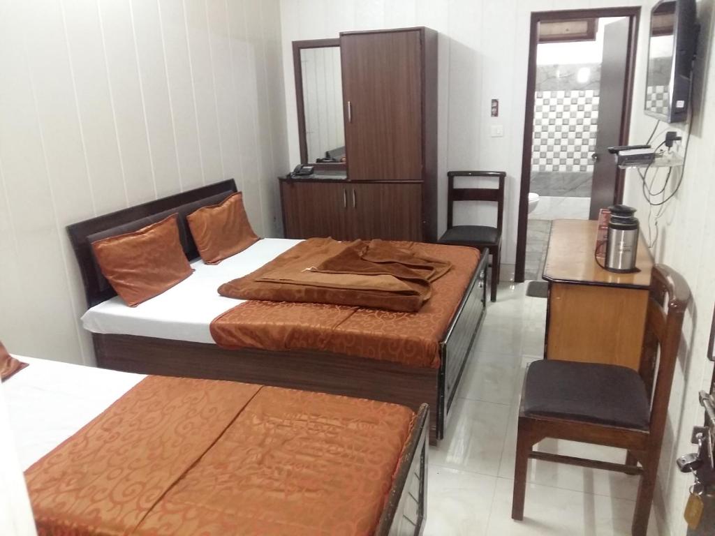 Postel nebo postele na pokoji v ubytování Hotel Grand