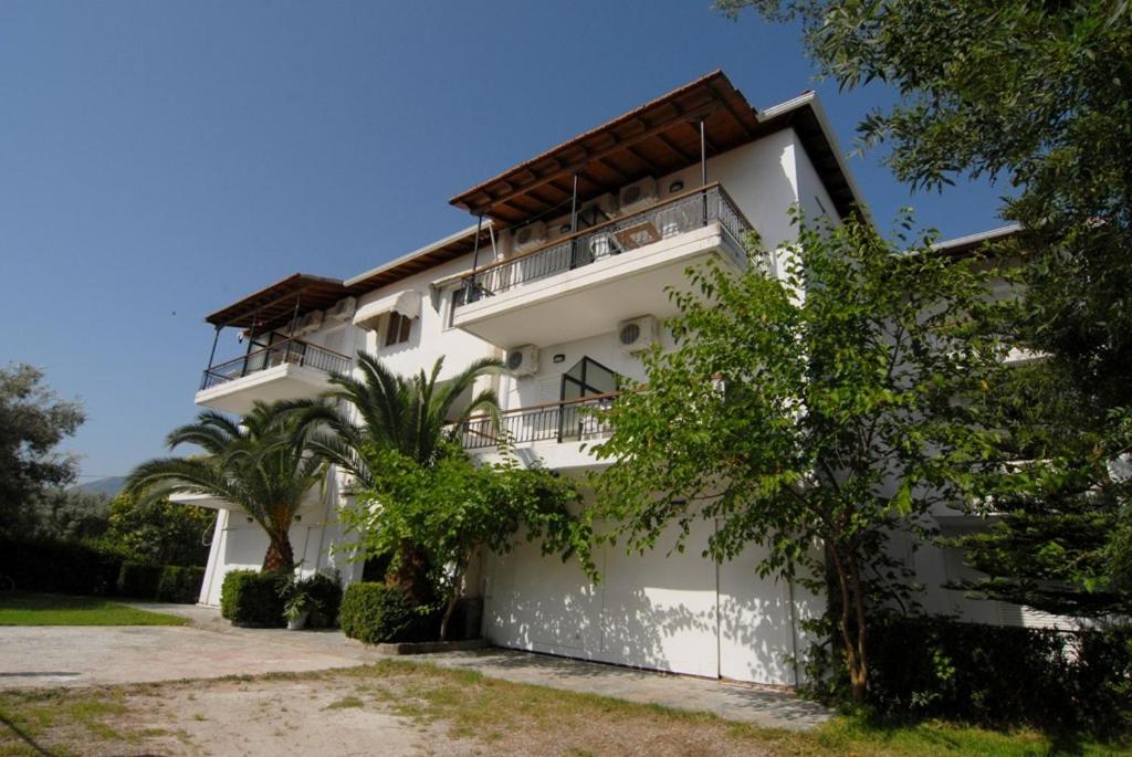 a white building with a balcony on top of it at Digenis Studios in Lygia