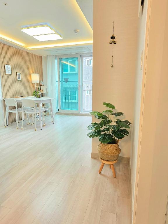 a living room with a potted plant and a table at Soul House in Seoul