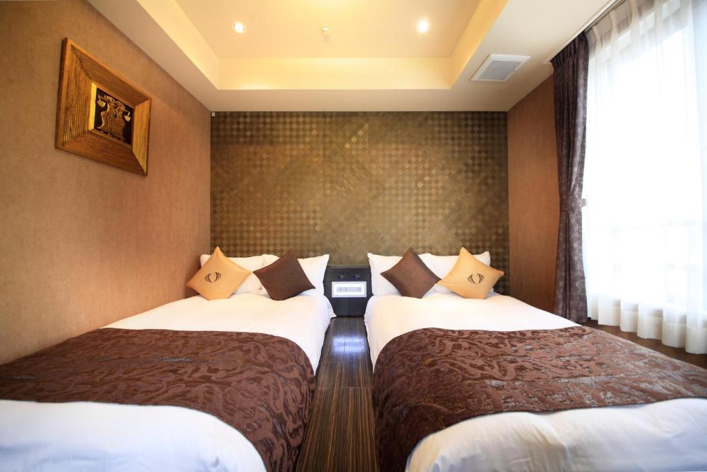 Postel nebo postele na pokoji v ubytování Hotel Coco Grand Kitasenju