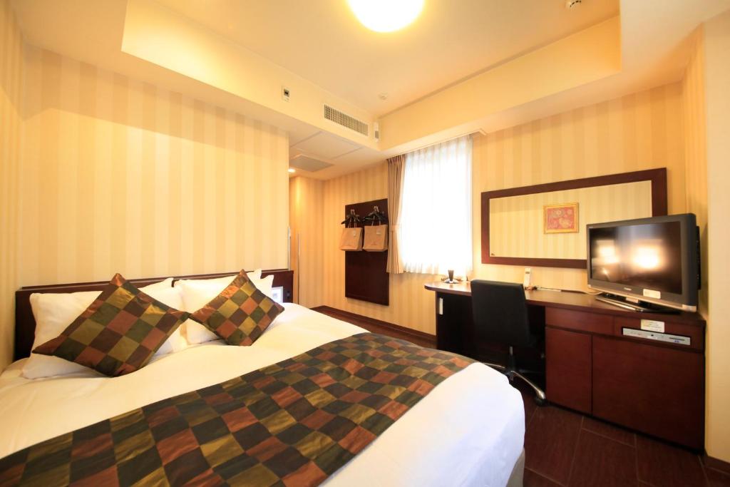 Postel nebo postele na pokoji v ubytování Hotel Coco Grand Kitasenju