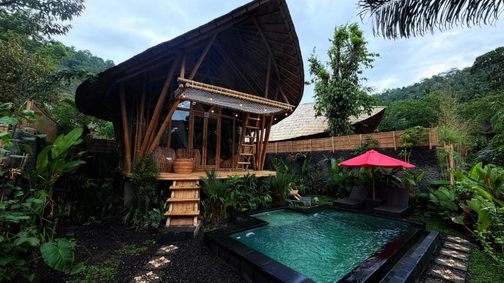 a resort with a swimming pool and a house at Wana Bamboo House by ecobreeze in Sidemen