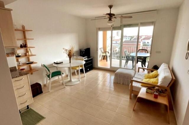 a living room with a couch and a table at Apartamento en playa de Torrenostra in Torrenostra