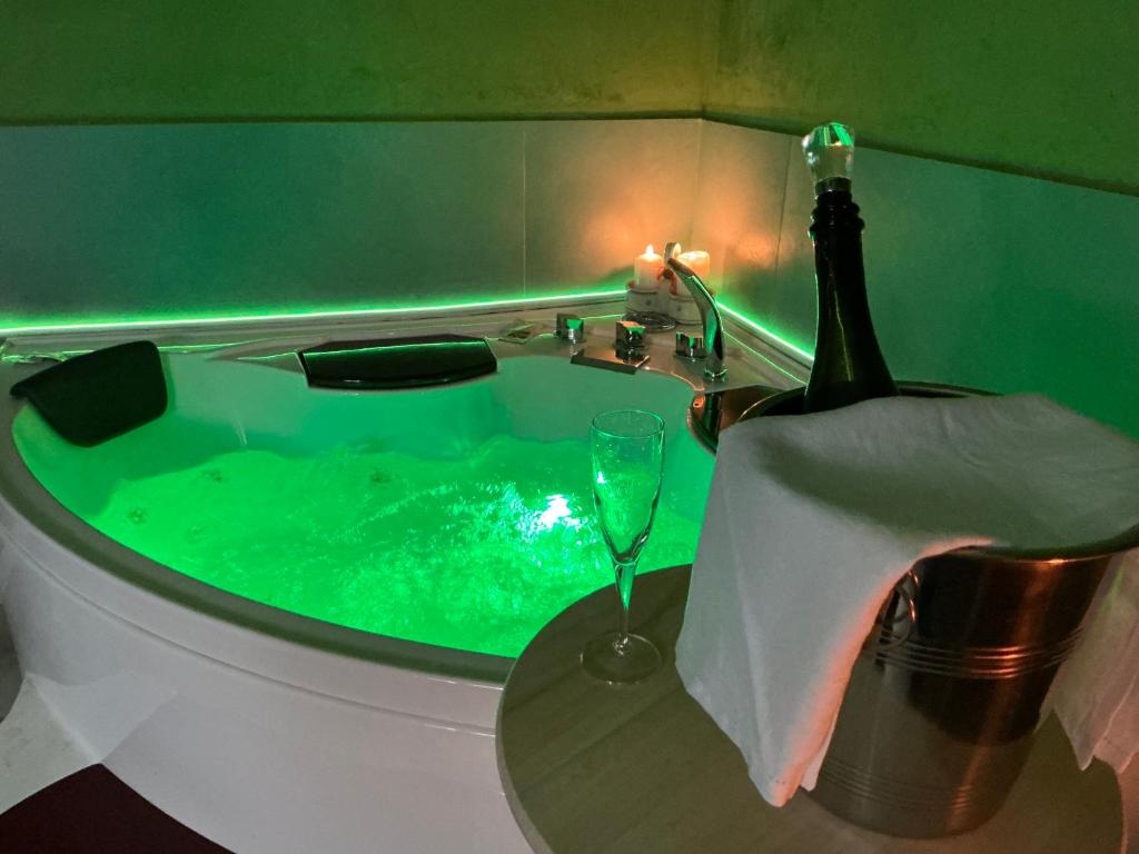 een bad met een fles wijn en een glas bij Lucias House in Lequile