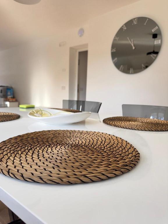 a table with plates and a clock on the wall at LP House in Rovereto