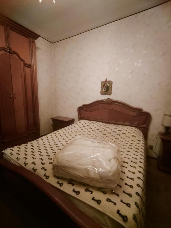 a bedroom with a bed with a white comforter at Lara home in Gaglianico