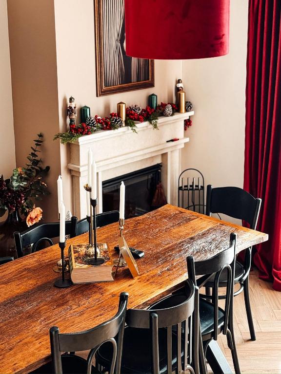 a dining room with a wooden table and a fireplace at Willow32 Chalet in Bran