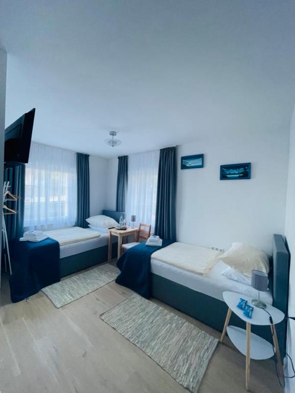 a room with two beds and a table in it at Aparts4ring 10, Nürburg in Nürburg