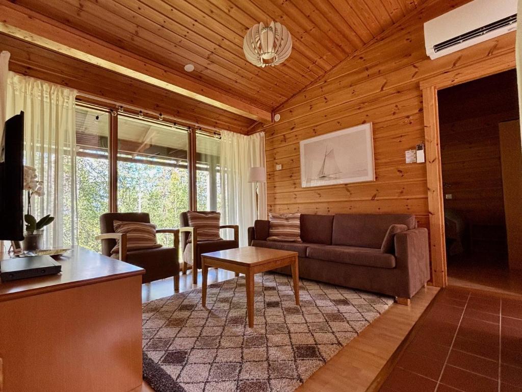 a living room with a couch and a table at Loma-aika in Vierumäki