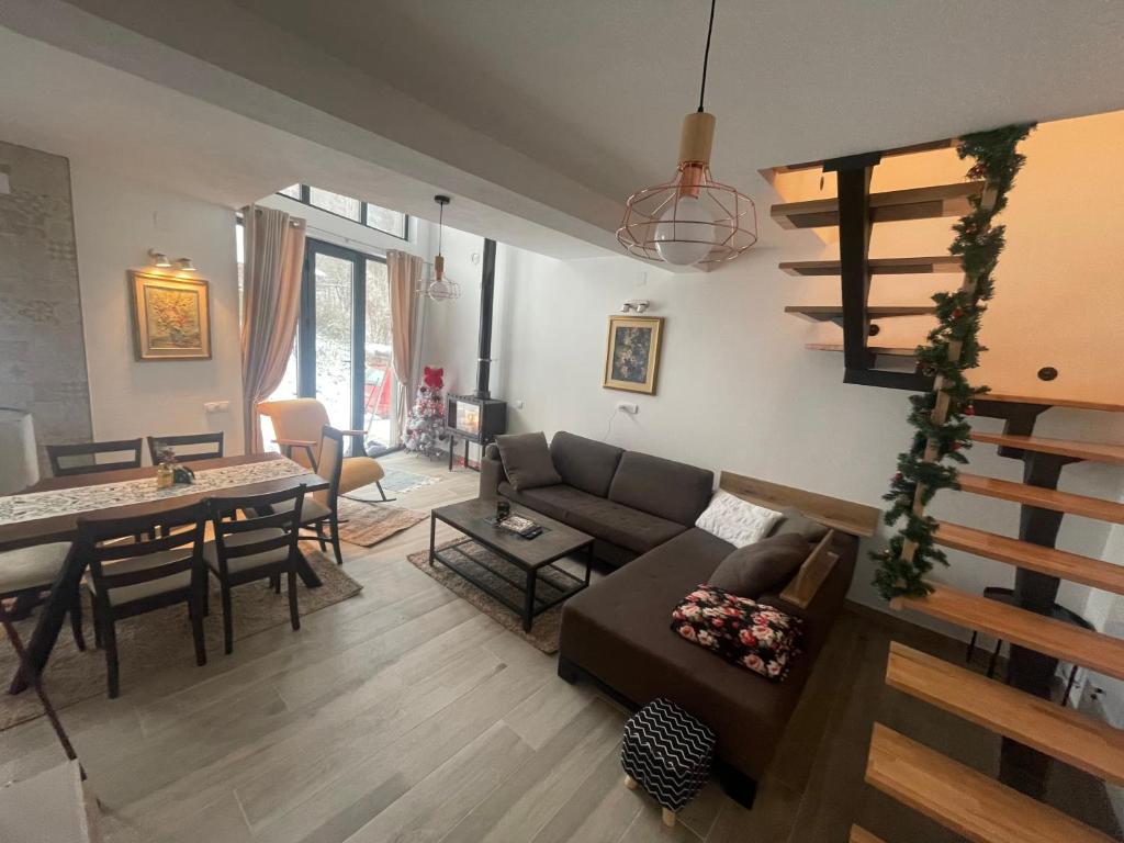 a living room with a couch and a table at Ćilibar Stara planina in Crni Vrh