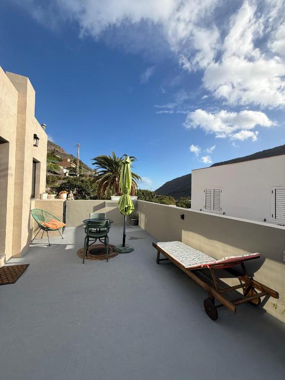 a patio with a table and chairs on a roof at Loft Mouly in San Sebastián de la Gomera