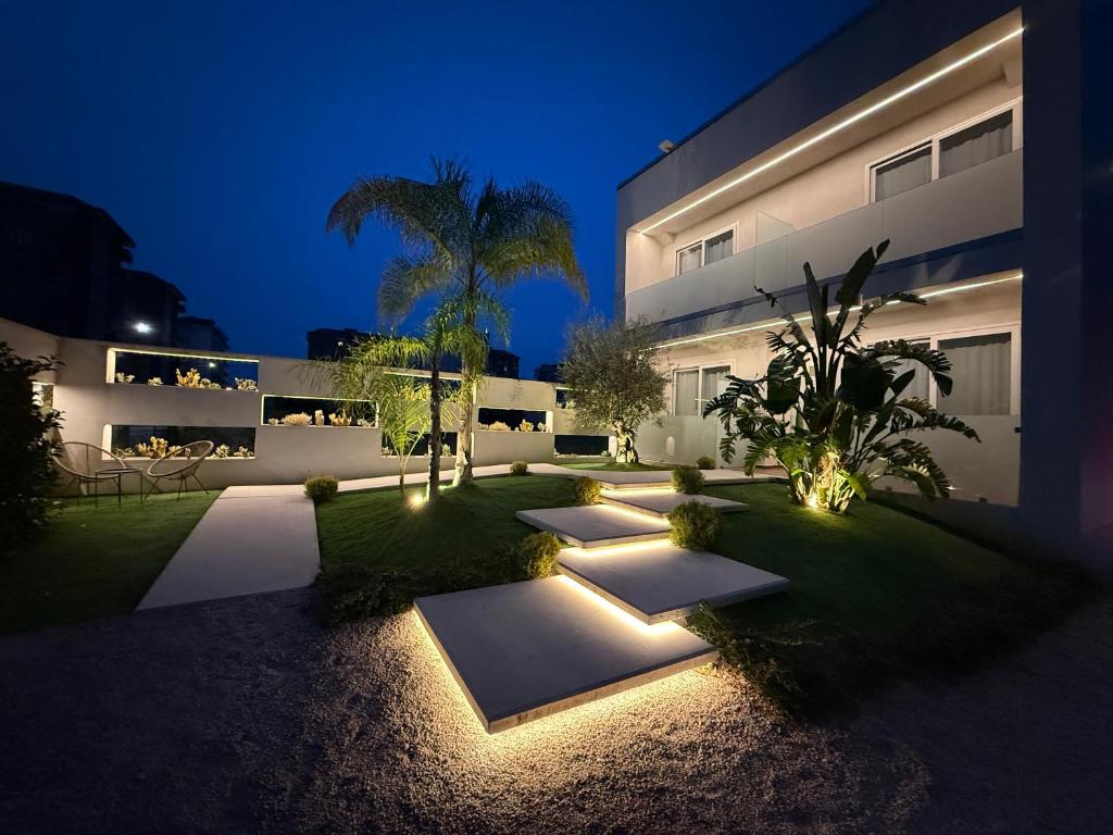 a courtyard of a building at night with lights at Eich Business Accommodation in Santa Maria Capua Vetere