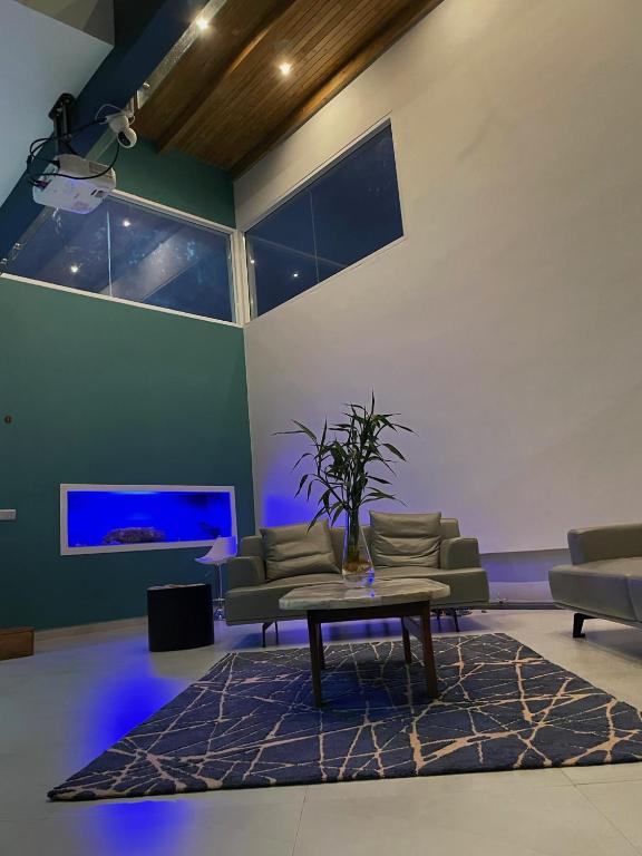 a living room with a couch and a table at Villa Oasis Antananarivo Private Stay in Antananarivo