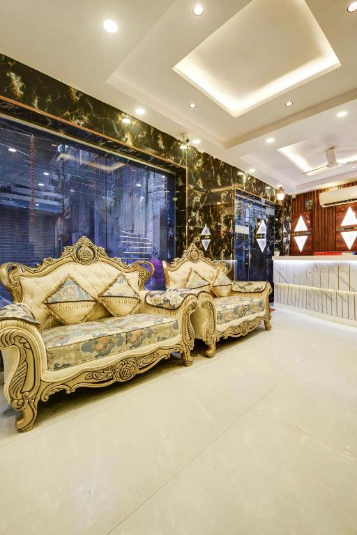 two beds in a room with gold furniture at Hotel Ruhi Dx - Near New Delhi Railway Station & Connaught Place in New Delhi
