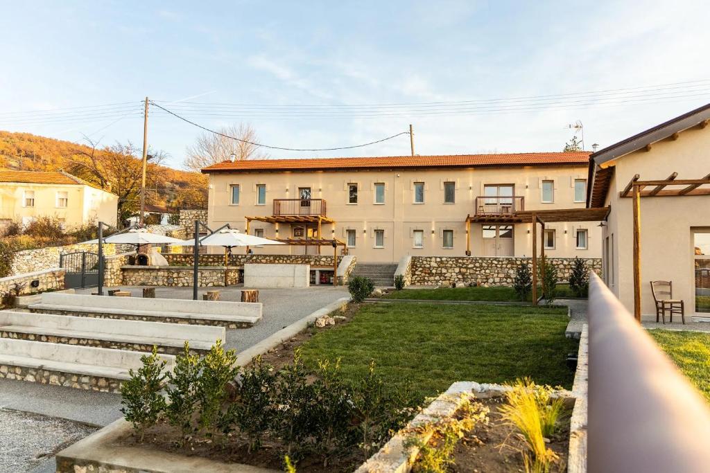 a view of a building with a yard at Vevi Villas in Vévi