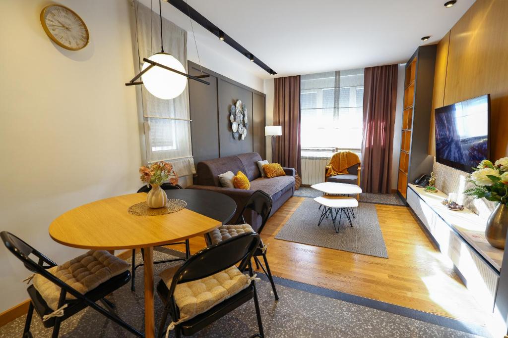 a living room with a table and a couch at Mia's Modern Mountain in Kolašin