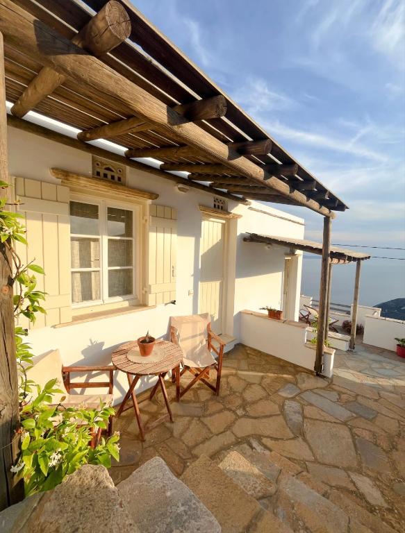 a patio of a house with a table and chairs at Katastega Tinos in Istérnia
