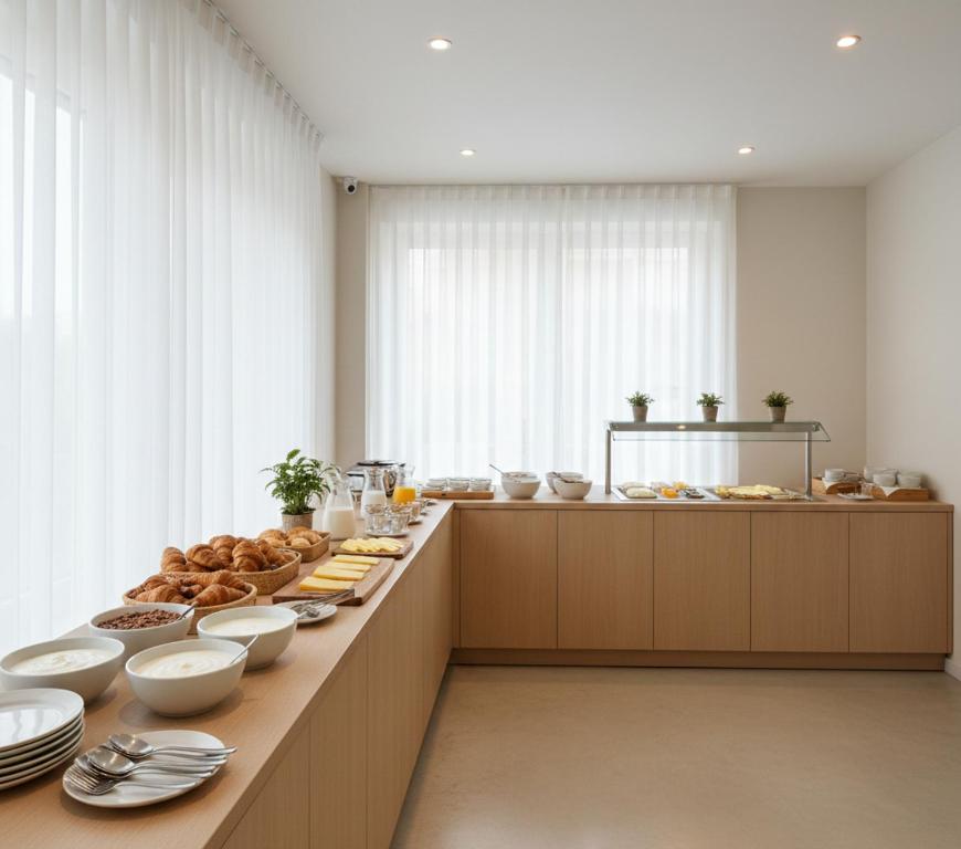 a kitchen with a long counter filled with food at Norvia Otel in Konya
