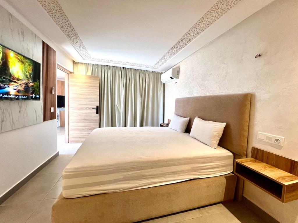 a bedroom with a large bed in a room at Lovely studio 4th floor No Elevator in El Gouassem