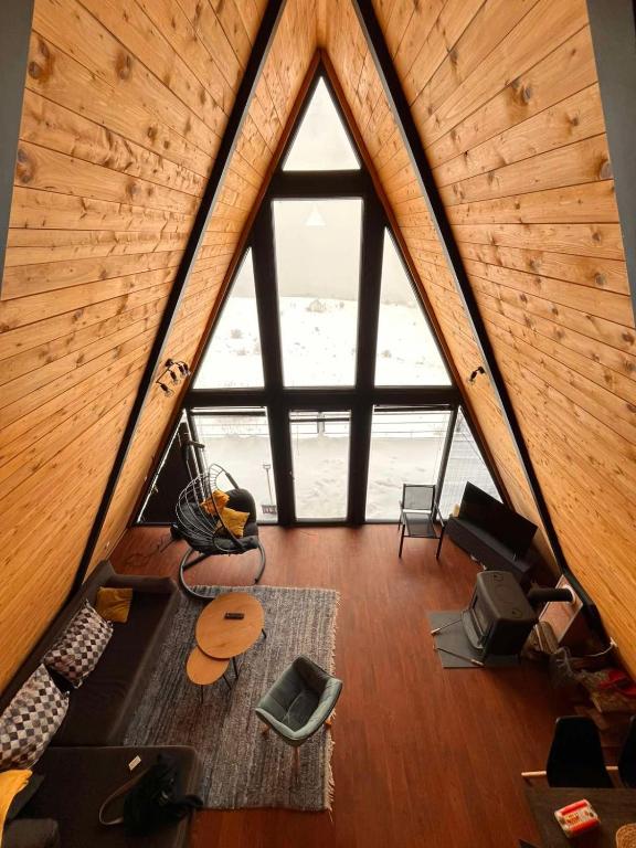 an attic room with a large window in a house at SUNSET Villa PONIKVA in Kočani