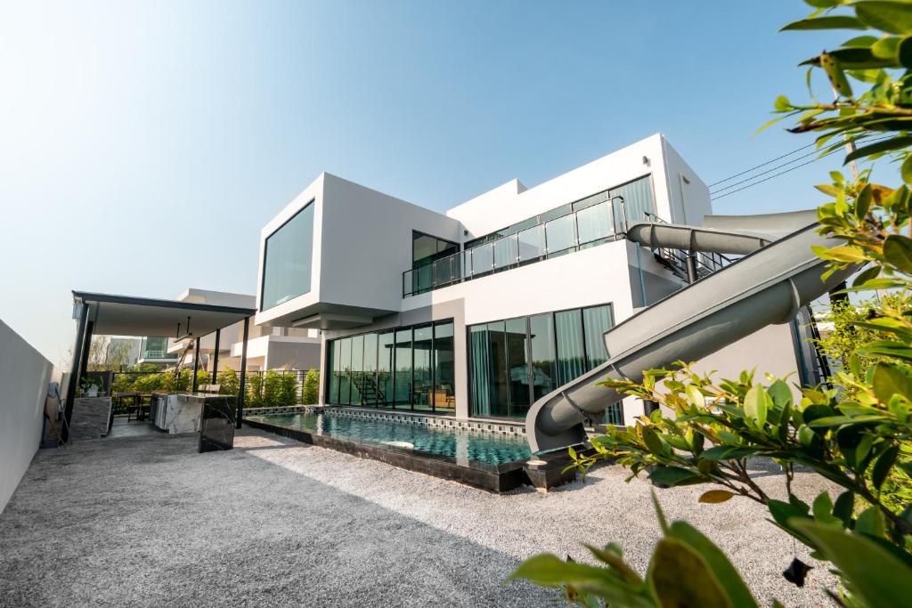 an exterior view of a house with a swimming pool at The Brick Huahin Pool Villa in Hua Hin