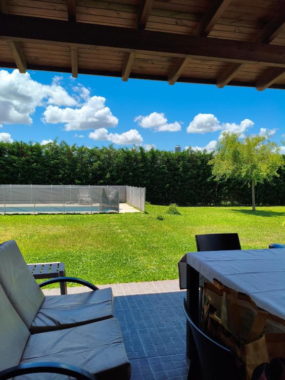 a patio with a table and chairs and a field at LA QUINTA DE LOLI in San Pedro