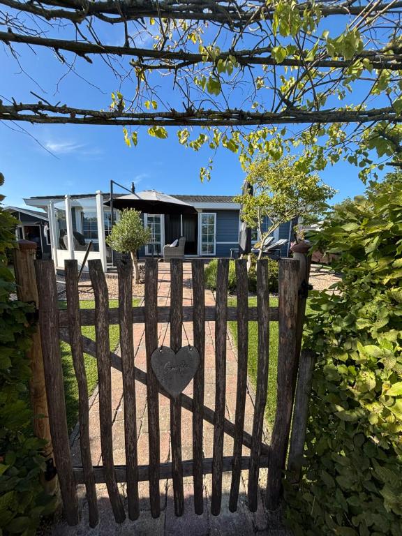 a gate with a heart on it in front of a house at Ferienhaus Breskens in Breskens
