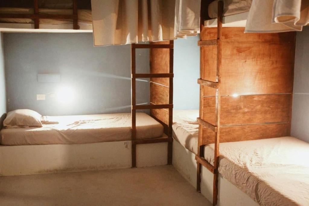 a room with two bunk beds and a ladder at Playa de la Fuente in El Paredón Buena Vista