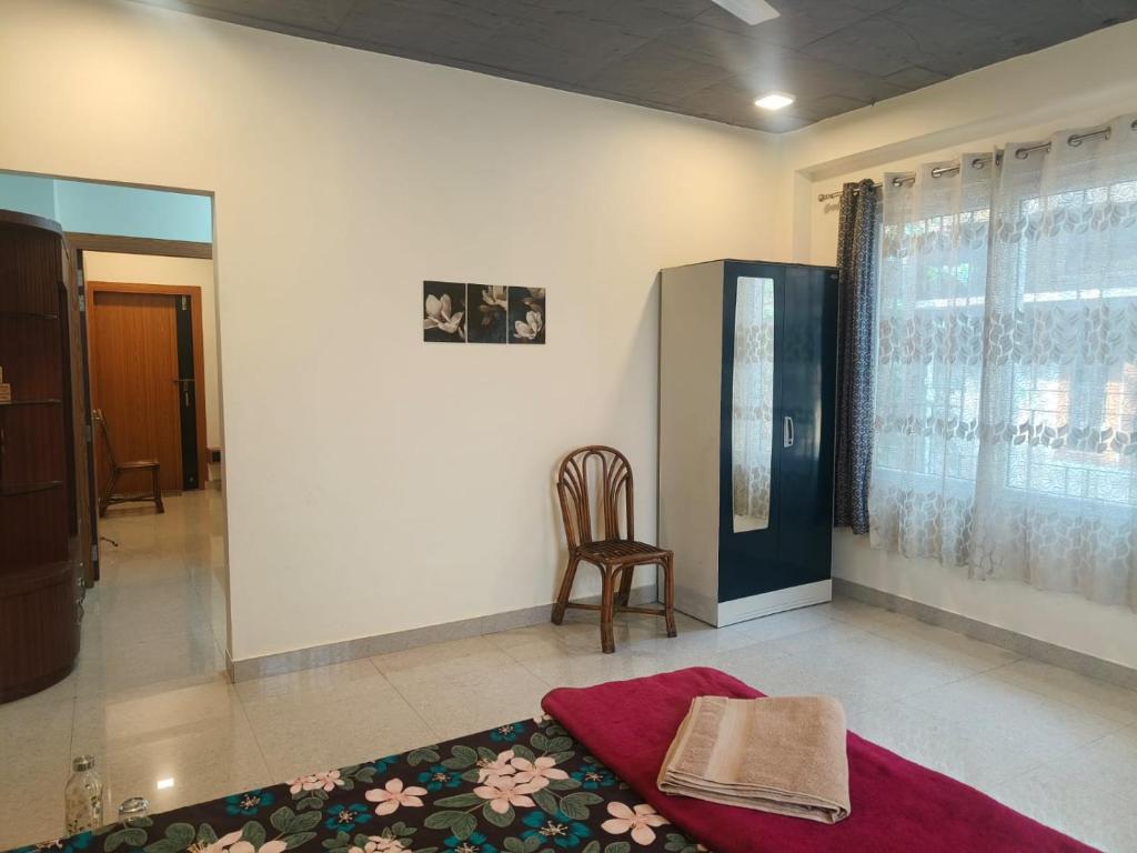 a living room with a chair and a table at Cleanslate homestay in Guwahati
